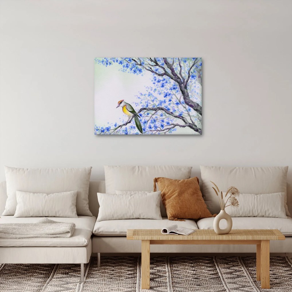 Obraz - ptak na drzewie z niebieskimi kwiatami (70x50 cm)