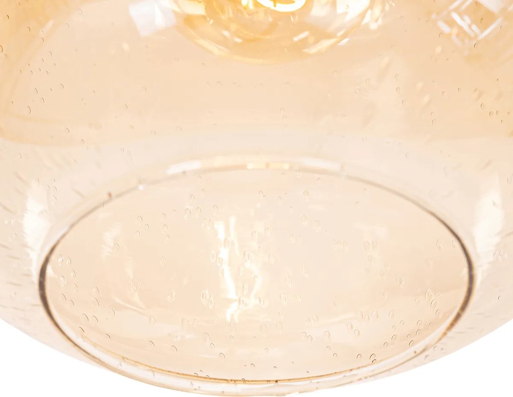 Designerska lampa wisząca czarna z mosiądzem i bursztynowym szkłem - Zuzanna