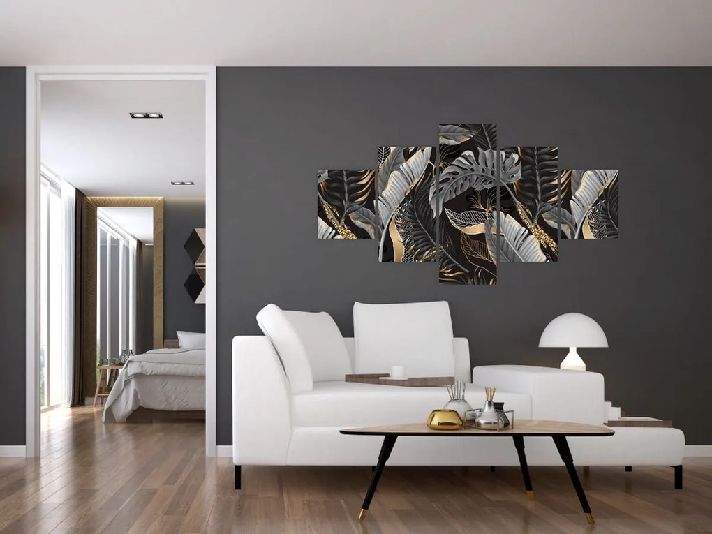 Obraz - Tropikalne liście w kolorze czarno - złotym (125x70 cm)