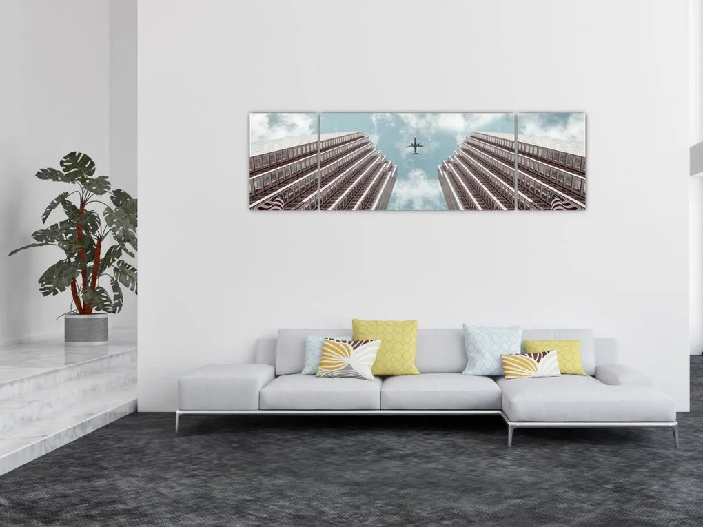 Obraz samolotu między budynkami (170x50 cm)
