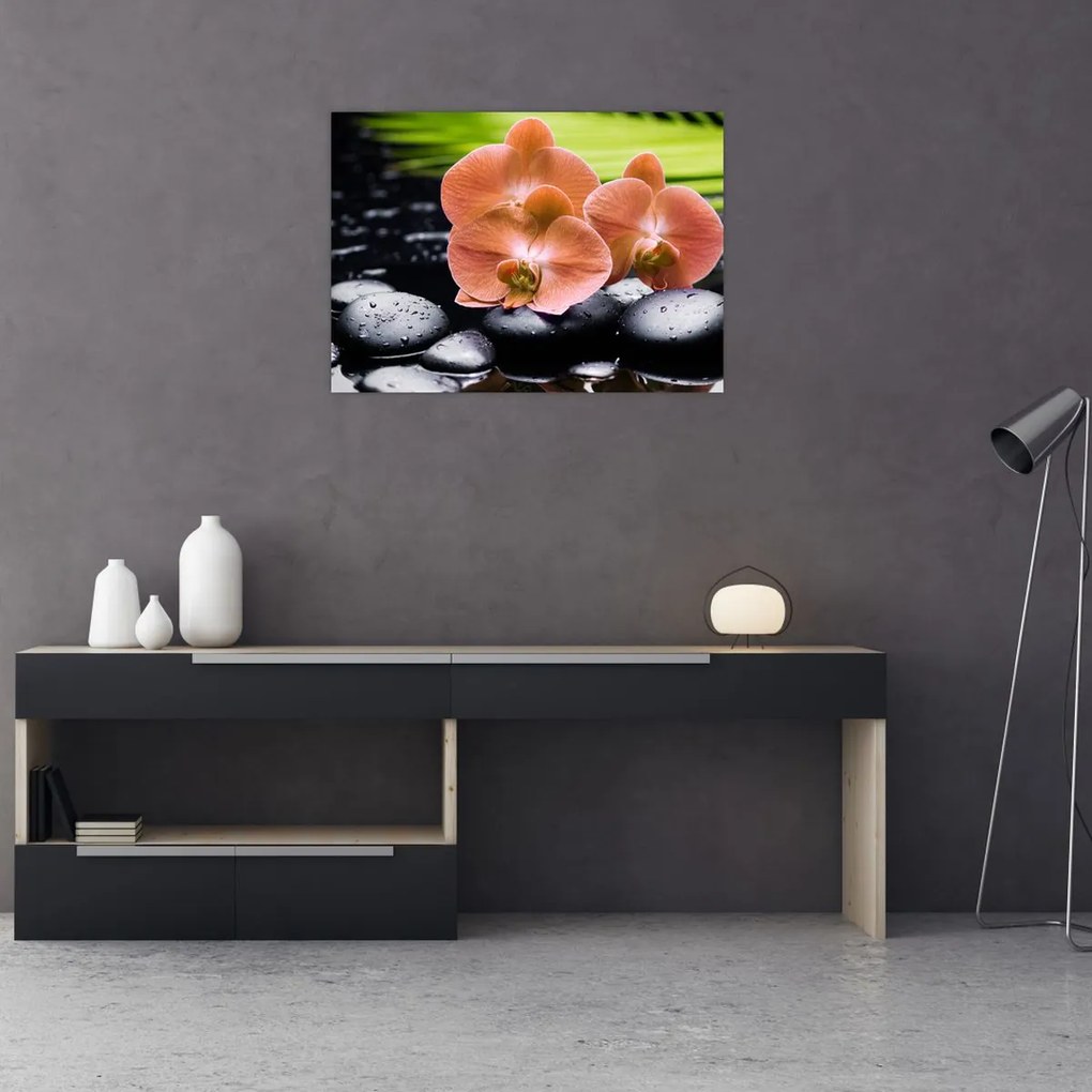 Obraz - Pomarańczowa orchidea z liśćmi palmy (70x50 cm)