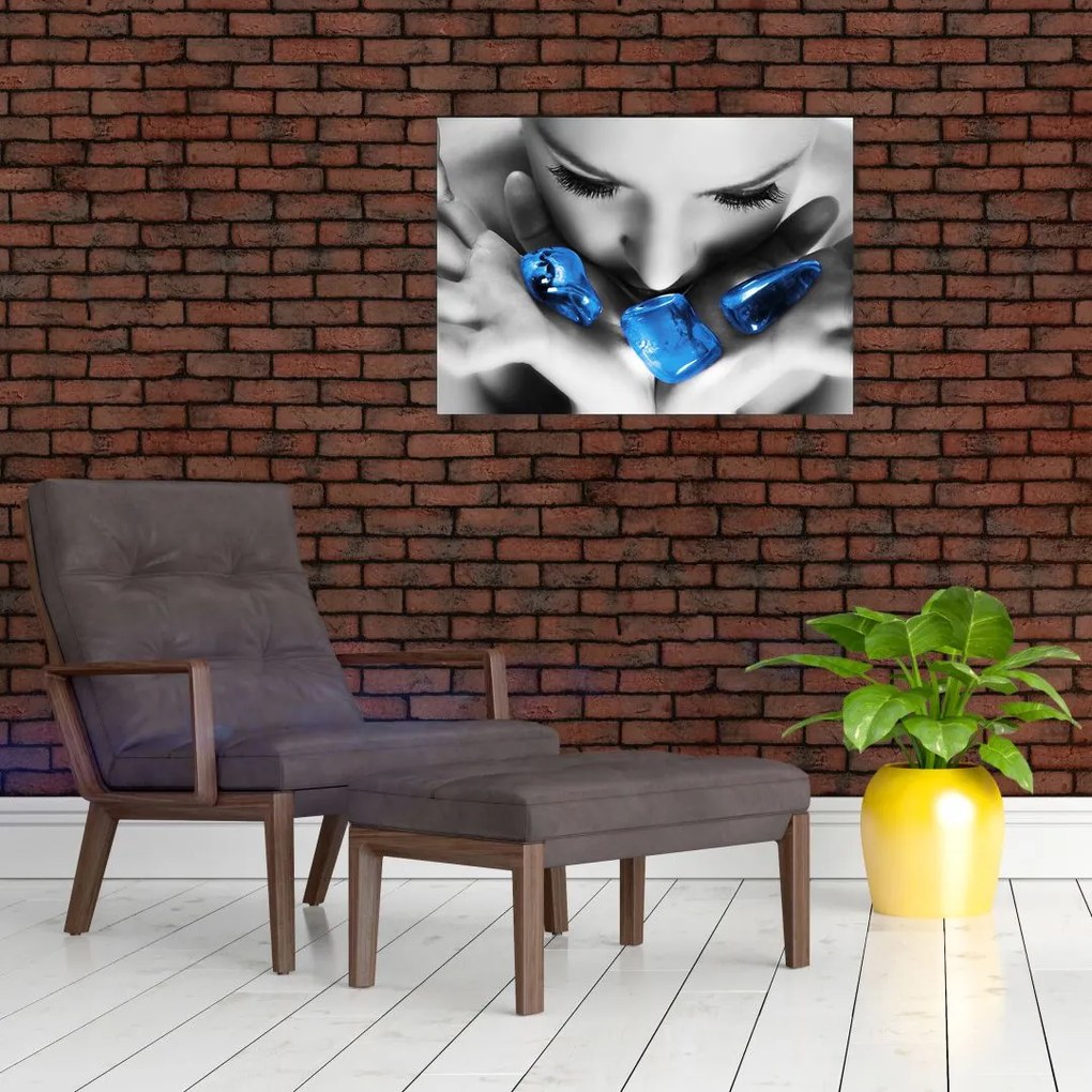 Obraz na szkle portretu kobiety z kamieniami (70x50 cm)