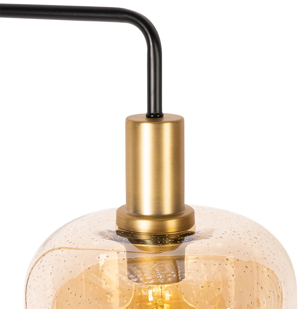 Designerska lampa podłogowa czarna z mosiądzem i bursztynowym szkłem - ZuzannaDesignerski Oswietlenie wewnetrzne