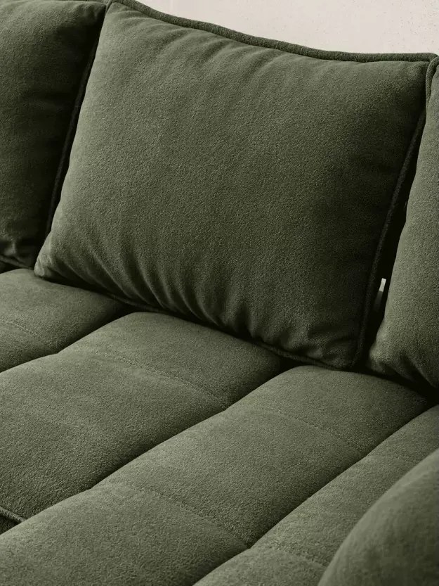 Nowoczesny narożnik Nalik L z eleganckimi przeszyciami oraz zagłówki na metalowych uchwytach
