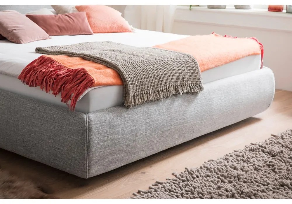 Szare tapicerowane łóżko dwuosobowe ze schowkiem i stelażem 180x200 cm Atesio – Meise Möbel