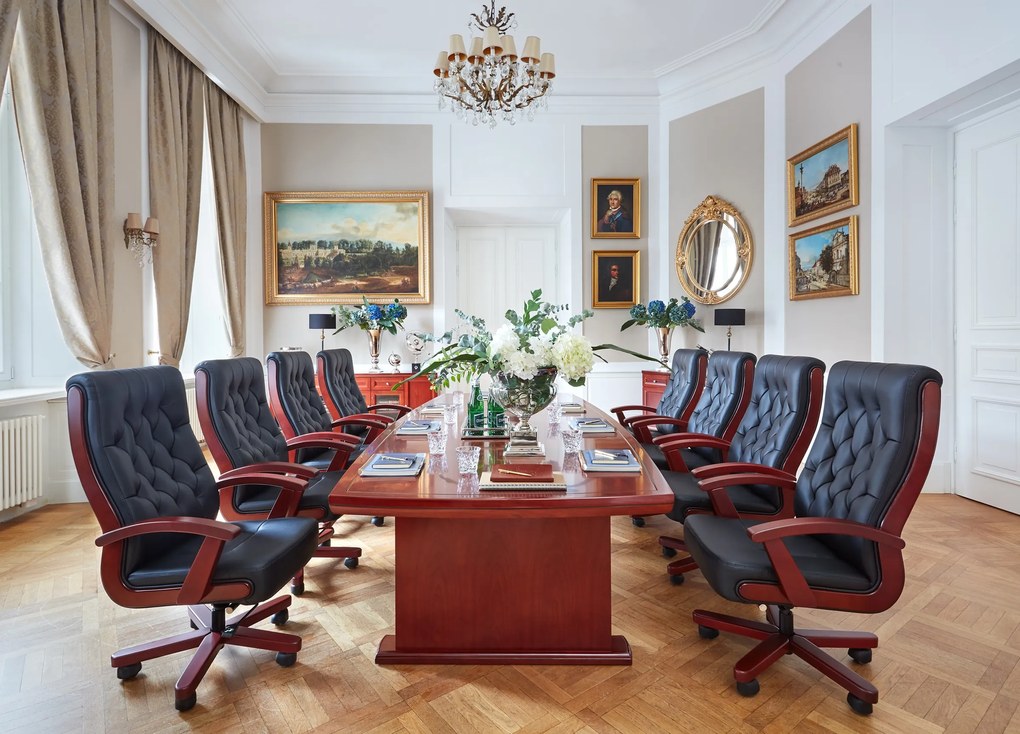 Duży stół konferencyjny o klasycznym wykończeniu. Dostępne wymiary 280x130 cm, 320x140 cm, 360x140 cm, 400x150 cm. Stół fornirowany drewnem, kolor koniak, solidna konstrukcja.