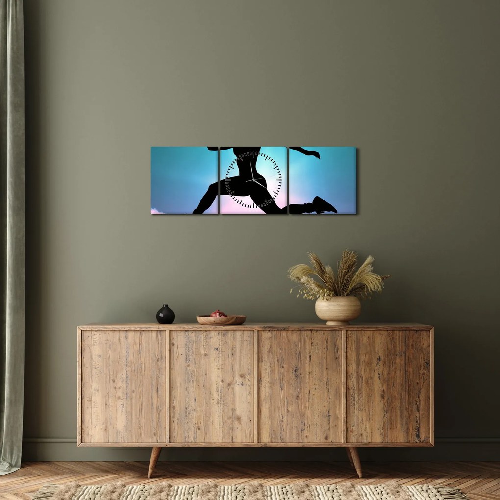 Obraz skaczącej sylwetki kobiety (z zegarem) (90x30 cm)