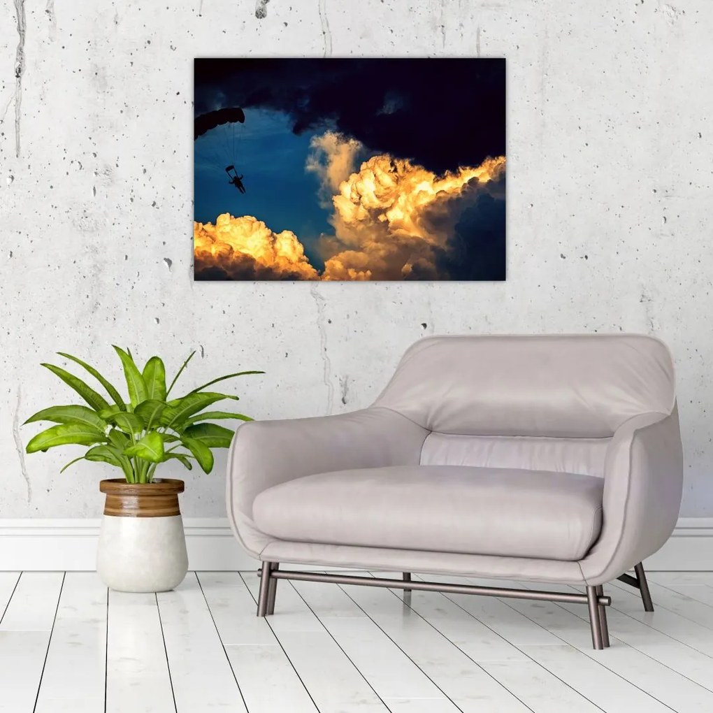 Obraz na szkle skoczka spadochronowego w chmurach (70x50 cm)