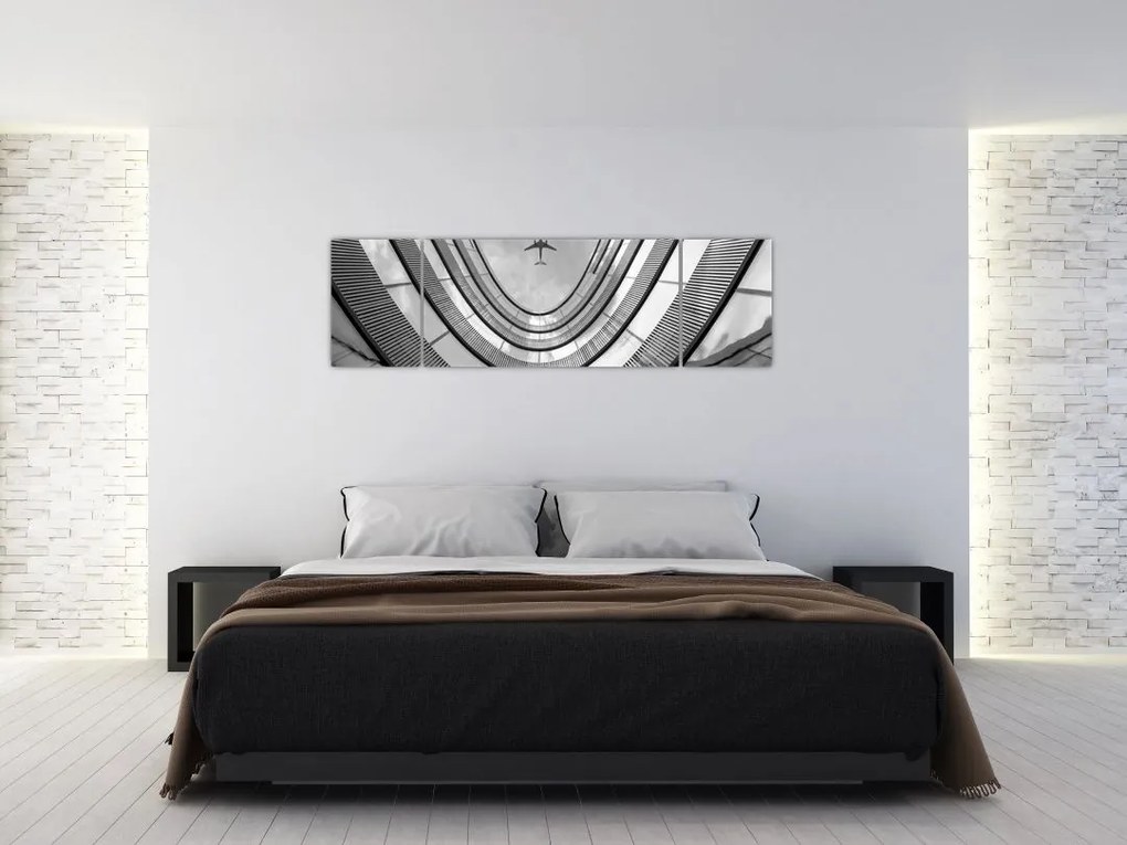 Obraz - Samolot nad budynkiem (170x50 cm)