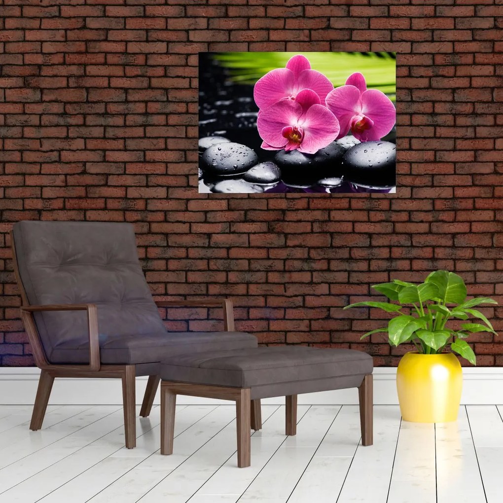 Obraz na szkle - Różowe orchidee z liściem palmy (70x50 cm)