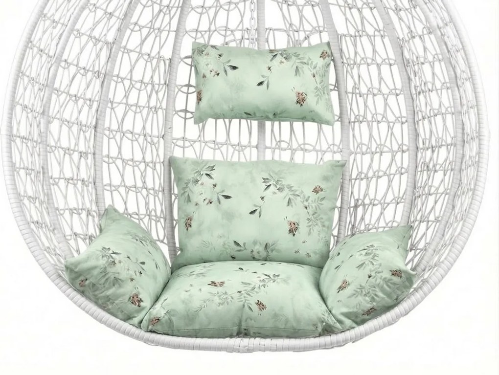 Białe wiszące krzesło KOKON ze stojakiem, jasnozielona poduszka ze wzorem