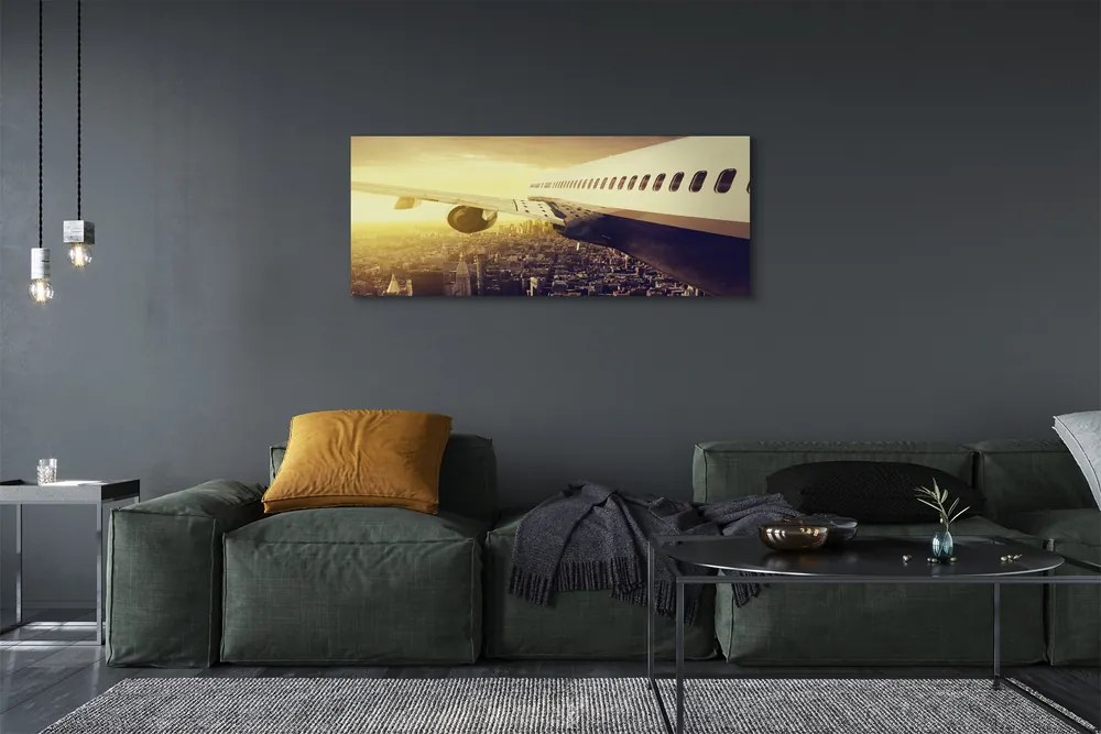 Obraz na płótnie Samolot nad Wieczornym Miastem