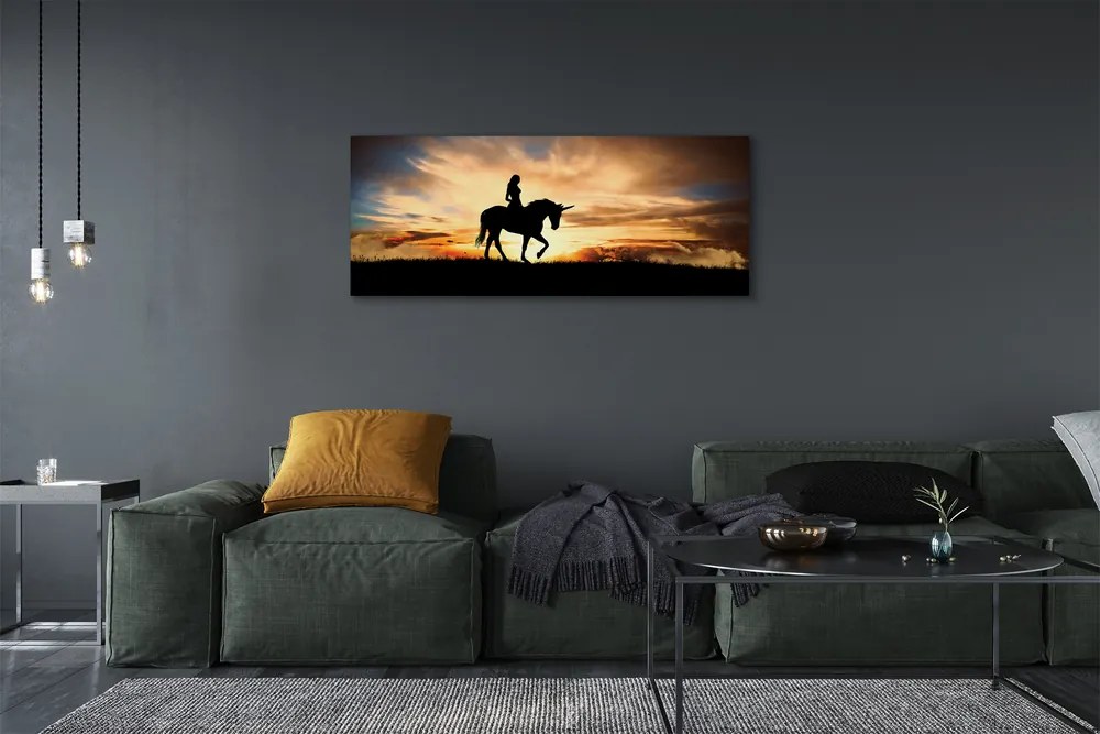 Obraz na płótnie Kobieta na Jednorożcu o Zachodzie Słońca