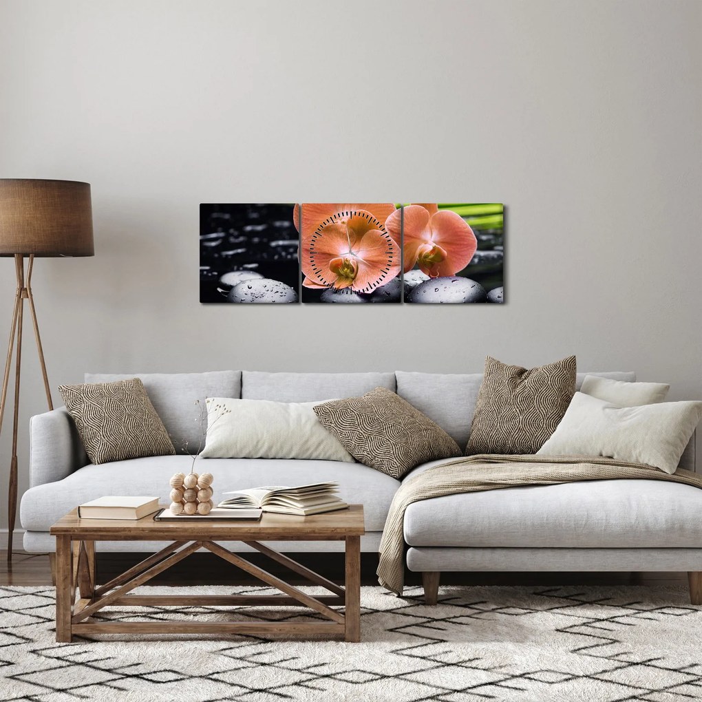 Obraz - Pomarańczowa orchidea z liśćmi palmy (z zegarem) (90x30 cm)