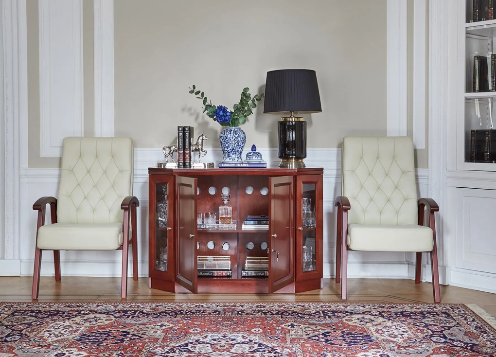 Komoda barek do gabinetu Elegance. W komodzie zmieści się mała lodówka. Komoda ma boczne drzwi przeszklone, przednie zabudowane, jest fornirowana, pięknie wykonana.