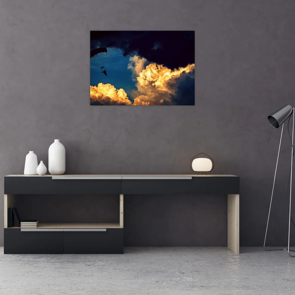 Obraz na szkle skoczka spadochronowego w chmurach (70x50 cm)