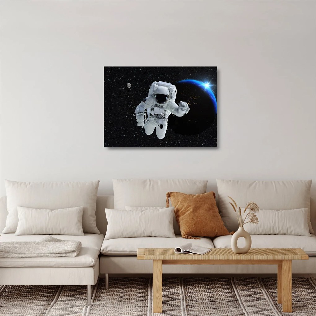 Obraz na szkle - Astronauta w kosmosie (70x50 cm)