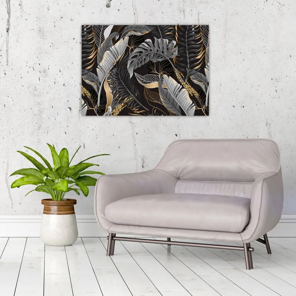 Obraz - Tropikalne liście w kolorze czarno - złotym (70x50 cm)