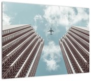 Obraz samolotu między budynkami (70x50 cm)