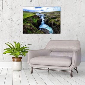 Obraz na szkle wodospadu między skałami (70x50 cm)