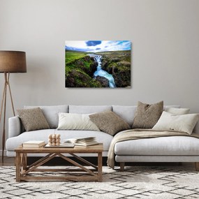 Obraz na szkle wodospadu między skałami (70x50 cm)