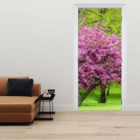 Fototapeta na drzwi - Kwitnące drzewo na łące (95x205cm)