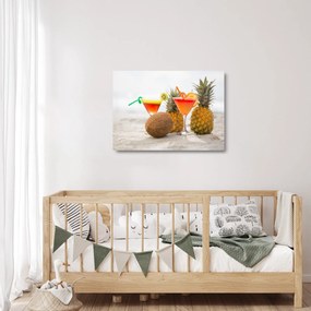 Obraz na szkle ananasów i szklanek na plaży (70x50 cm)