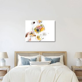 Obraz na szkle talerzy z owocami na stole (70x50 cm)
