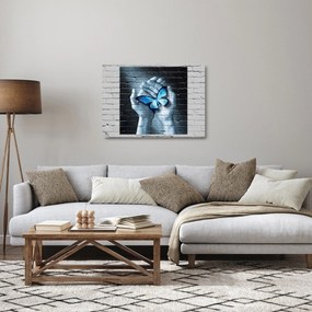 Obraz na szkle niebieskiego motyla na ścianie (70x50 cm)
