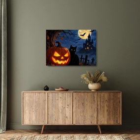 Obraz na szkle - Czarny kot przy świecącej dyni na Halloween (70x50 cm)