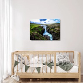 Obraz na szkle wodospadu między skałami (70x50 cm)