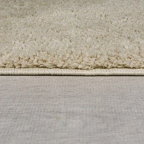 Beżowy okrągły dywan z włókien z recyklingu odpowiedni do prania 133x133 cm Fluffy – Flair Rugs