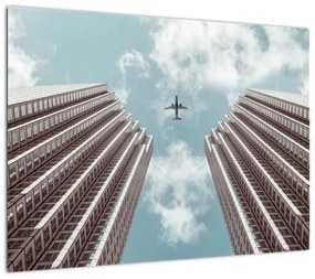 Obraz na szkle samolotu między budynkami (70x50 cm)