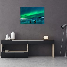 Obraz na szkle ludzi w pobliżu zorzy polarnej (70x50 cm)