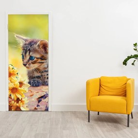 Fototapeta na drzwi - Kotek patrzący na kwiat (95x205cm)