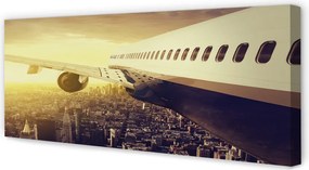 Obraz na płótnie Samolot nad Wieczornym Miastem