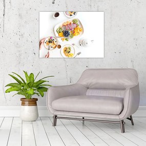 Obraz na szkle talerzy z owocami na stole (70x50 cm)