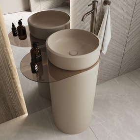 Umywalka z konglomeratu wolnostojąca okrągła z półką szklaną 85 x 40 cm RONA bez przelewu | Różne kolory półki : Kolor szkła - Przezroczyste , Kolor umywalki RONA - Beż matowy, Podłączenie syfonu - Do ściany, Półka - Szklana