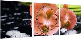 Obraz - Pomarańczowa orchidea z liśćmi palmy (z zegarem) (90x30 cm)