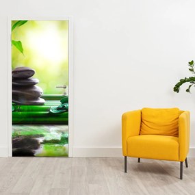 Fototapeta na drzwi - Kamienie do masażu i orchidea na wodzie (95x205cm)