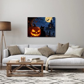 Obraz na szkle - Czarny kot przy świecącej dyni na Halloween (70x50 cm)