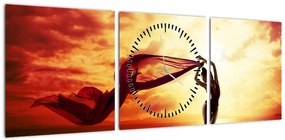 Obraz - Sylwetka kobiety o zachodzie słońca (z zegarem) (90x30 cm)