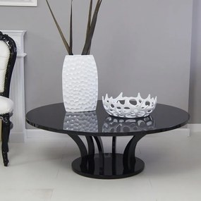 Czarny, okrągły stolik, wysoki połysk, styl modernistyczny.