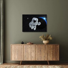 Obraz na szkle - Astronauta w kosmosie (70x50 cm)