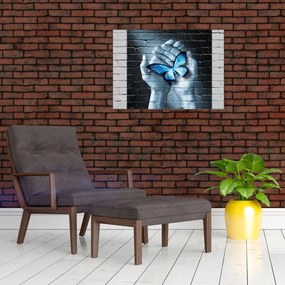 Obraz na szkle niebieskiego motyla na ścianie (70x50 cm)