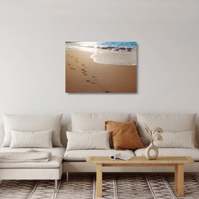 Obraz na szkle - ślady stóp na piasku i morzu (70x50 cm)