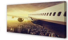 Obraz na płótnie Samolot nad Wieczornym Miastem