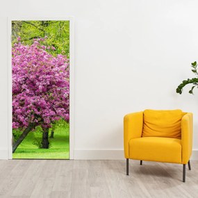 Fototapeta na drzwi - Kwitnące drzewo na łące (95x205cm)