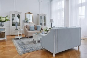 Kanapa sofa dwuosobowa do salonu. Sofa na drewnianych nóżkach, tapicerowana tkaniną welwetową. Sofa ma eleganckie podłokietniki, krawędzie obszyte kedrą, niebieska lub beżowa.